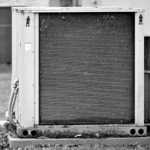 Close-up of an AC coil and metal fins before deep cleaning