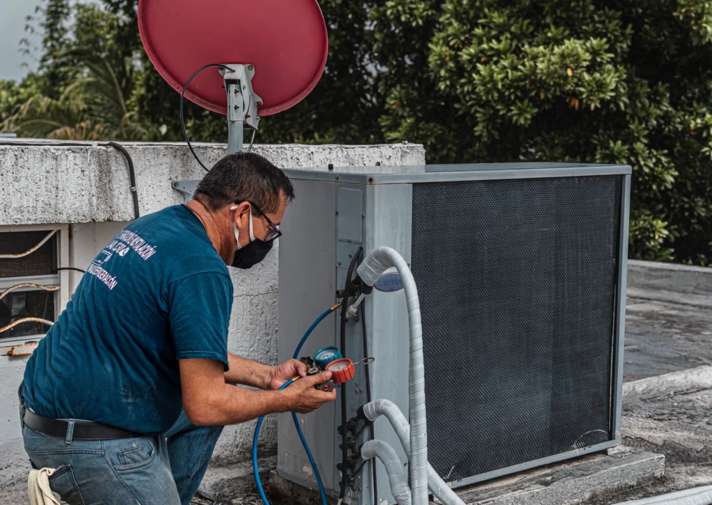 AC technician servicing an air conditioning unit in Dubai